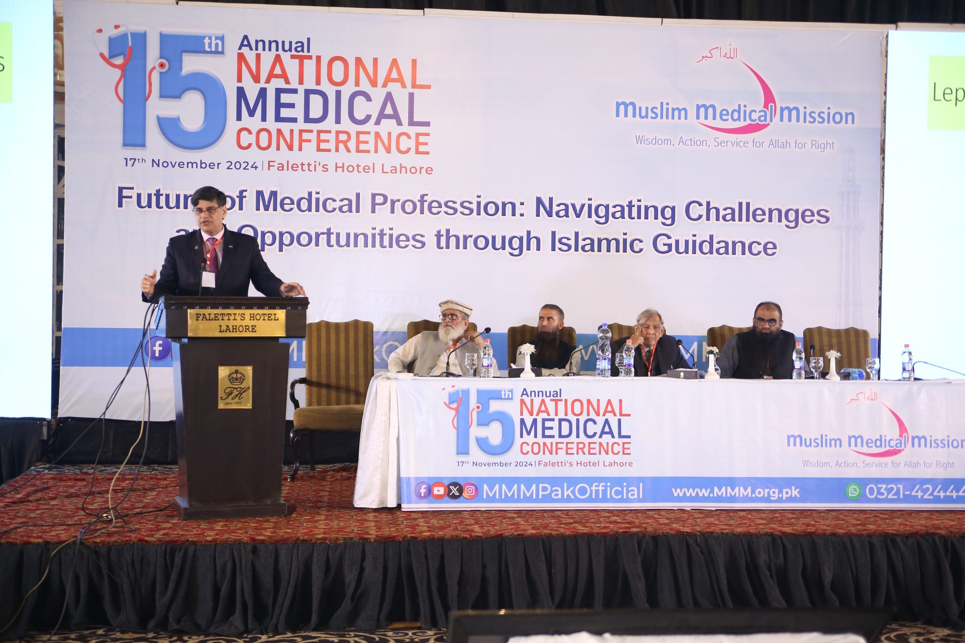 Audience and delegates gathered at the Muslim Medical Mission National Medical Conference with grand official stage banner
